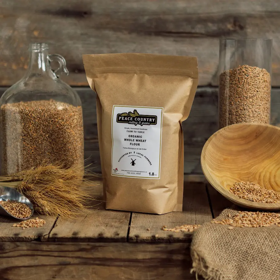 A wooden table with some grains of wheat