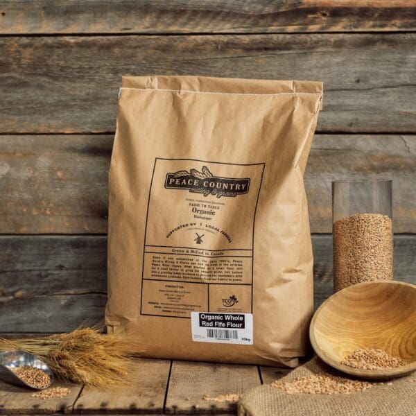 A bag of flour sitting on top of a wooden table.