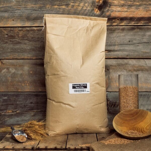 A bag of grain sitting on top of a wooden table.