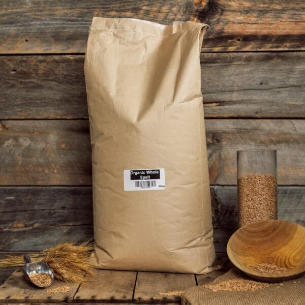 A bag of wood chips next to a wooden wall.