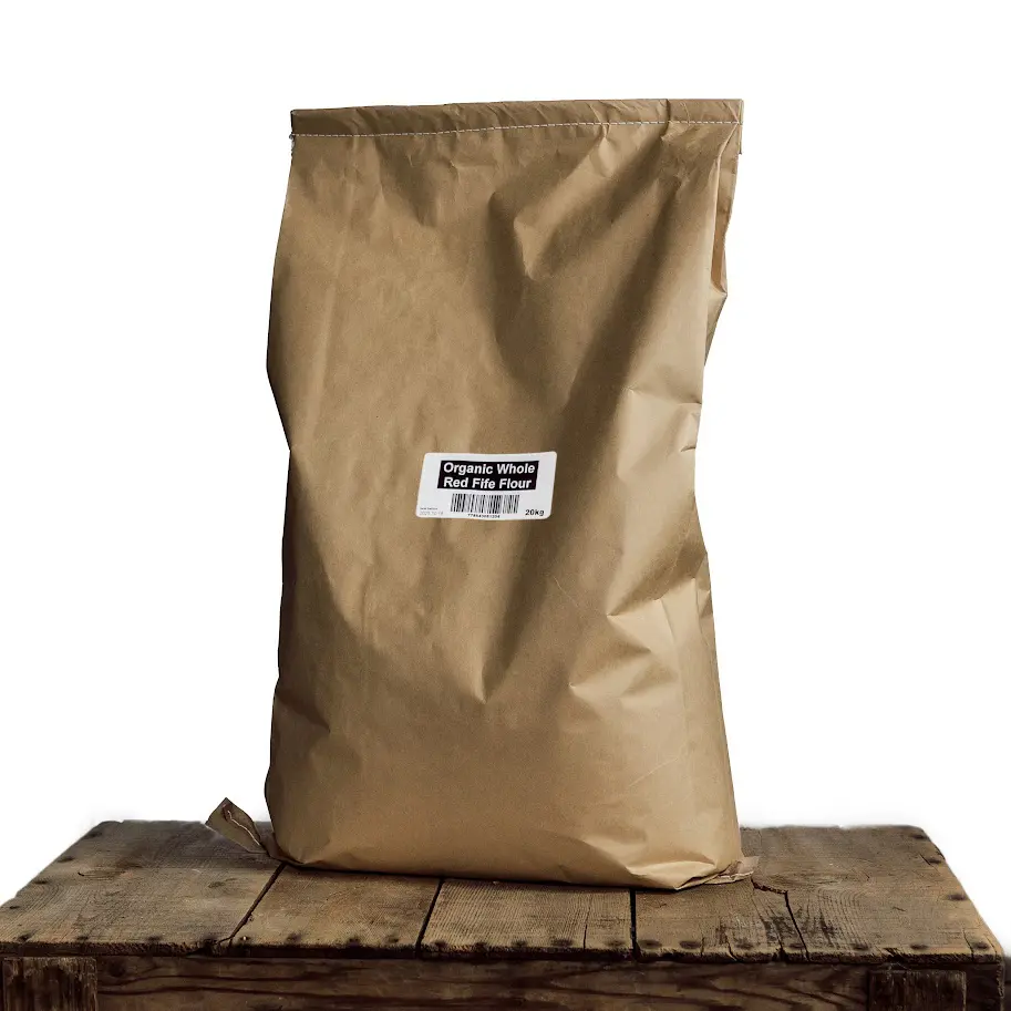 A brown bag sitting on top of a wooden table.